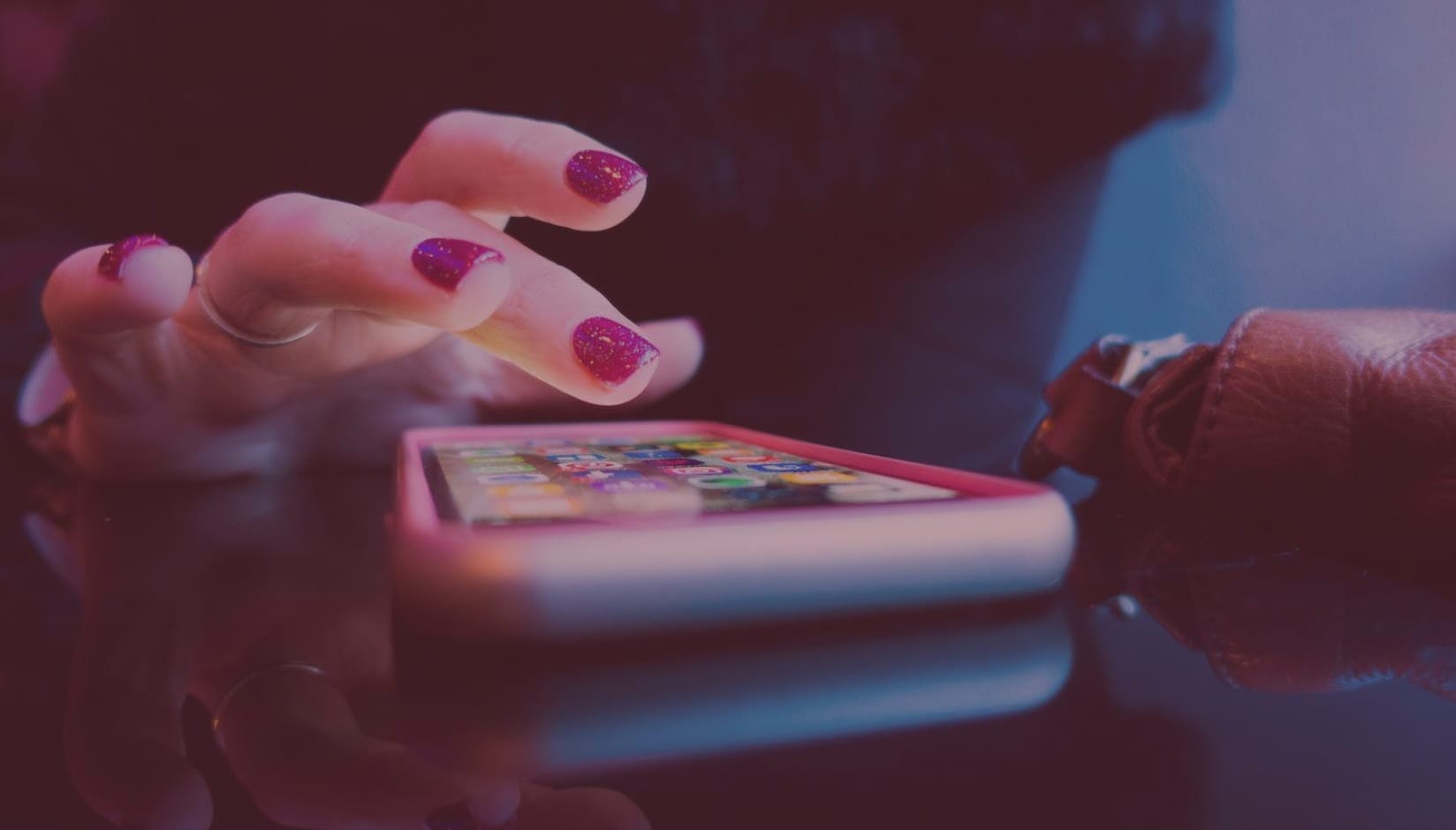 female hand getting ready to tap coworking space app on a smartphone